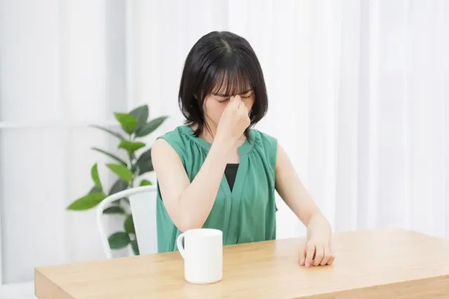 女性がなんとなく辛そうにしている図