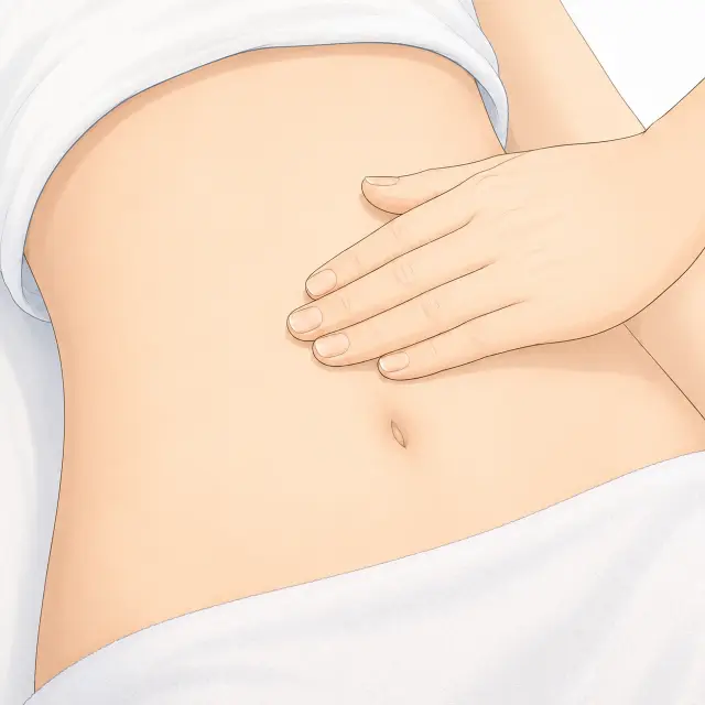 お腹を指腹で押す様子